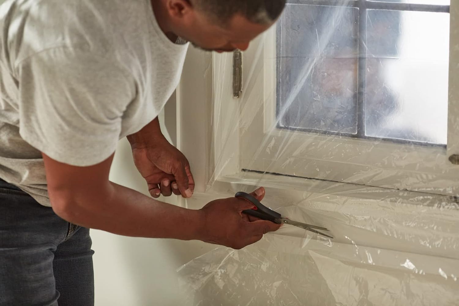 Applying Duck insulation film to living room window